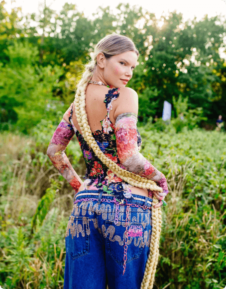 A Collina Strada model wears bedecked Baggy Fit jeans on the runway at Naval Cemetery Landscape in Brooklyn.
