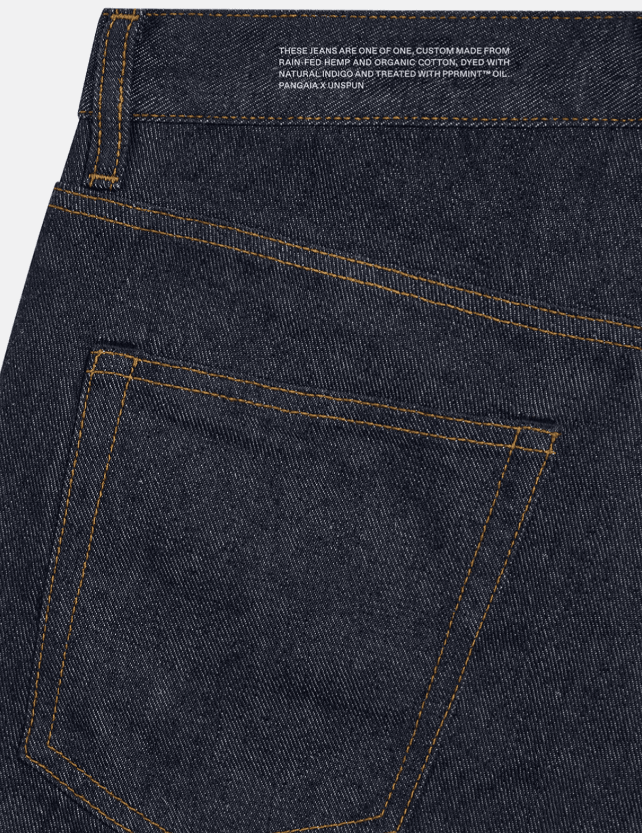 A pair of jeans made with PANhemp™ denim in rinse wash features Pangaia’s signature text block, which imparts the plant-based materials composing it.
