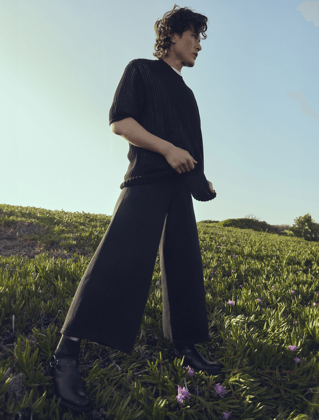 Model standing in a field.