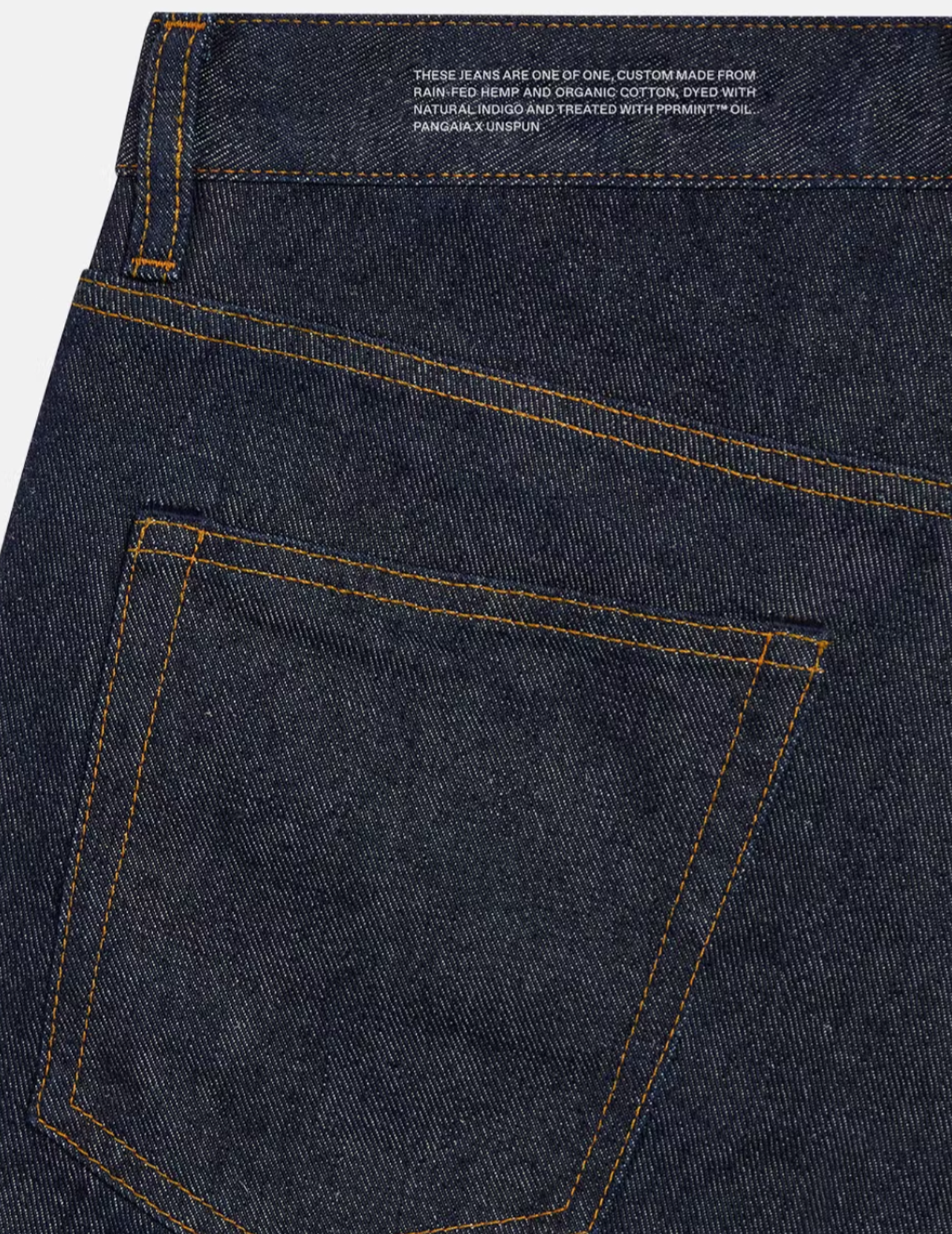 A pair of jeans made with PANhemp™ denim in rinse wash features Pangaia’s signature text block, which imparts the plant-based materials composing it.